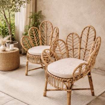 Handwoven cane chair with sculptural backrest design