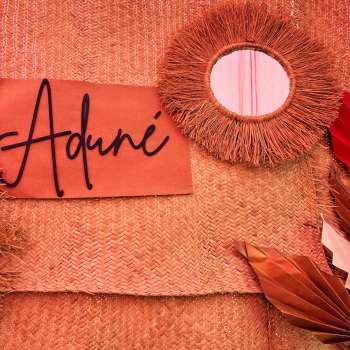 A handwoven raffia mirror designed to soften your space.12-inch round raffia-framed wall mirror