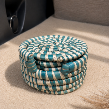 Set of five handwoven natural fibre coasters with matching woven holder by Aduné Home