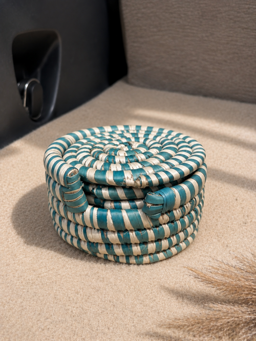 Set of five handwoven natural fibre coasters with matching woven holder by Aduné Home