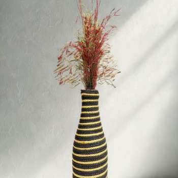 Handcrafted bottle vase wrapped in textured wool, featuring soft pampas grass — minimal modern home décor by Aduné