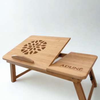 adjustable bamboo mobile desk. styled in a cosy setting,, used for meals or work. it is the desk that movies with you and makes life more convenient