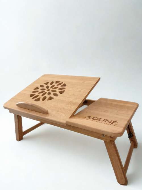 adjustable bamboo mobile desk. styled in a cosy setting,, used for meals or work. it is the desk that movies with you and makes life more convenient