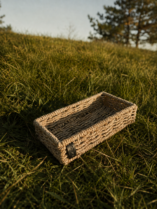 Handwoven natural fibre Ritual Tray from Aduné Home’s Minis Collection, styled outdoors in warm natural light.